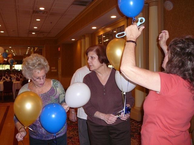 The committee getting ready for the reunion, Marilyn Jaffie Richie & Jennith Liner Kuperstein with Harriet Rosen Liebowitz working on balloons